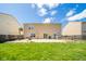Backyard view of the home and patio, showing a grill, outdoor seating and grass at 5820 Marble Ct, Anderson, IN 46013