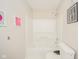 Clean white bathroom featuring a bathtub and shower combination and toilet at 5820 Marble Ct, Anderson, IN 46013
