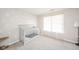 Bedroom featuring soft carpeting, a gray crib, and a brightly lit window at 5820 Marble Ct, Anderson, IN 46013