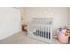 Bright Bedroom with a gray crib, daisy decals, and ample space for storage at 5820 Marble Ct, Anderson, IN 46013