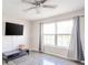 Bright bedroom with ceiling fan, large window with curtains, and hardwood floors at 5820 Marble Ct, Anderson, IN 46013
