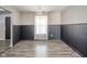Dining room featuring hardwood floors, board and batten, and a view of the front entry at 5820 Marble Ct, Anderson, IN 46013