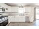 Well-lit kitchen featuring white cabinetry, stainless steel appliances, and modern countertops at 5820 Marble Ct, Anderson, IN 46013