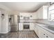 Bright kitchen with stainless steel appliances, subway tile backsplash, and white cabinetry at 5820 Marble Ct, Anderson, IN 46013