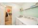 Laundry room with a white washer and dryer, white wire shelving, and closet with storage at 5820 Marble Ct, Anderson, IN 46013