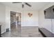 Open living room with hardwood floors, ceiling fan, and a view to the entryway at 5820 Marble Ct, Anderson, IN 46013