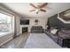 Bright living room with fireplace, hardwood floors, ceiling fan, and two comfortable couches at 5820 Marble Ct, Anderson, IN 46013