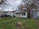 Modest single story home with a small yard and walkway at 5842 Greenfield Ave, Indianapolis, IN 46219
