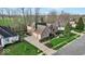 Brick and siding home features a two-car garage, driveway, and manicured lawn at 5861 Dawnwood Dr, Carmel, IN 46033