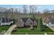 Stunning aerial view of home with expansive lawn, mature trees, and well-maintained landscaping at 5861 Dawnwood Dr, Carmel, IN 46033