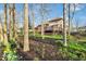 A backyard with a raised wooden deck, brick and siding exterior, and daffodils at 5861 Dawnwood Dr, Carmel, IN 46033