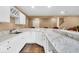 Basement wet bar with a marble countertop and white cabinetry at 5861 Dawnwood Dr, Carmel, IN 46033