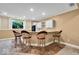Basement wet bar with neutral walls, four stools, and tile floor at 5861 Dawnwood Dr, Carmel, IN 46033