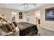 Bedroom featuring a tray ceiling and ensuite bathroom at 5861 Dawnwood Dr, Carmel, IN 46033
