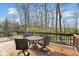 Outdoor dining on wooden deck with a table and seating overlooking a green landscape at 5861 Dawnwood Dr, Carmel, IN 46033