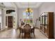 Formal dining room boasts hardwood floors, chandelier, and entryway to the front door at 5861 Dawnwood Dr, Carmel, IN 46033