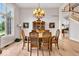 Formal dining room features hardwood floors, chandelier, and large windows with natural light at 5861 Dawnwood Dr, Carmel, IN 46033