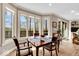 Charming dining room with many windows overlooking outdoor deck at 5861 Dawnwood Dr, Carmel, IN 46033