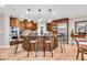 Gourmet kitchen features a center island with seating, custom cabinetry, and stainless appliances at 5861 Dawnwood Dr, Carmel, IN 46033