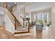 Elegant living room boasts hardwood floors, staircase, and an abundance of natural light at 5861 Dawnwood Dr, Carmel, IN 46033