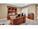 This office features a wooden desk, hutch, and trim with neutral paint at 5861 Dawnwood Dr, Carmel, IN 46033