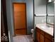 Bathroom featuring a sink with wooden cabinets, mirror and walk in closet at 607 Deer Trail Dr, Indianapolis, IN 46217