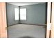 A bedroom with neutral colored walls and carpet, along with two windows that brighten up the space at 607 Deer Trail Dr, Indianapolis, IN 46217