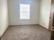 This bedroom is carpeted and is bathed in natural light from the window, creating a warm and inviting space at 607 Deer Trail Dr, Indianapolis, IN 46217