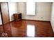 Comfortable bedroom with sleek wood floors and a storage shelf for added convenience at 607 Deer Trail Dr, Indianapolis, IN 46217