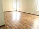 Sun-drenched bedroom featuring attractive wood-look floors and bright windows with white blinds at 607 Deer Trail Dr, Indianapolis, IN 46217