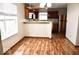 Bright dining area with wood-look flooring, natural light, and a modern stainless steel refrigerator at 607 Deer Trail Dr, Indianapolis, IN 46217