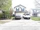 Two-story home with vinyl siding, dark shutters, and an attached two-car garage at 607 Deer Trail Dr, Indianapolis, IN 46217