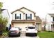 Two-story home with vinyl siding, dark shutters, and an attached two-car garage at 607 Deer Trail Dr, Indianapolis, IN 46217