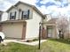 Two-story home with vinyl siding, dark shutters, and an attached two-car garage at 607 Deer Trail Dr, Indianapolis, IN 46217