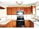 Functional kitchen featuring stainless steel appliances and wood cabinets at 607 Deer Trail Dr, Indianapolis, IN 46217