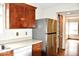 Efficient kitchen with white appliances and stylish wooden cabinets, offering ample storage at 607 Deer Trail Dr, Indianapolis, IN 46217