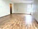 Spacious living room with wood-look flooring, a front door, and plenty of natural light at 607 Deer Trail Dr, Indianapolis, IN 46217