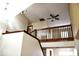 Staircase featuring wooden banister, white walls and ceiling fan at 607 Deer Trail Dr, Indianapolis, IN 46217