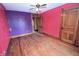 Spacious bedroom featuring hardwood floors, ceiling fan, and ample natural light at 609 E Columbus St, Martinsville, IN 46151