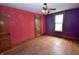 Charming bedroom features wood floors, tall windows, and two points of ingress at 609 E Columbus St, Martinsville, IN 46151