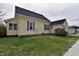 An inviting yellow home with a side view showcasing its classic design and yard space at 609 E Columbus St, Martinsville, IN 46151