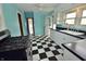 Kitchen with black and white checkered floors, turquoise walls, and stainless steel oven at 609 E Columbus St, Martinsville, IN 46151