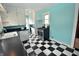 Kitchen with black and white checkered floors, stainless steel oven, and turquoise walls at 609 E Columbus St, Martinsville, IN 46151