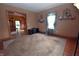 A cozy living room with hardwood floors and neutral carpet, awaiting personal touches at 609 E Columbus St, Martinsville, IN 46151