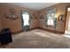 Spacious living room featuring hardwood floors, plush carpet, and natural light at 609 E Columbus St, Martinsville, IN 46151