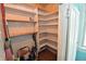 Walk-in pantry with multiple shelves for storage, including a window at 609 E Columbus St, Martinsville, IN 46151