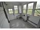 Bright sunroom featuring tile flooring, ample windows, and a door to the outside, perfect for relaxation and plants at 609 E Columbus St, Martinsville, IN 46151
