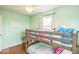 Bright and airy bedroom featuring bunk beds, hardwood flooring, and calming green walls at 6133 Buttonwood Dr, Noblesville, IN 46062