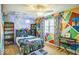 Fun bedroom with colorful geometric wall and video game theme at 6133 Buttonwood Dr, Noblesville, IN 46062