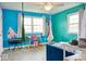 Stylish bedroom with blue walls, natural light, and unique hanging chair for relaxation at 6133 Buttonwood Dr, Noblesville, IN 46062